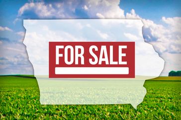 Outline of Iowa state with for sale text over it farmland in the background
